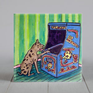 May include: A painting of a dog playing an arcade game. The arcade machine is blue with the words "Pac-Man" on it. The dog is brown with black spots and is sitting next to the arcade machine. The background is green and white striped.
