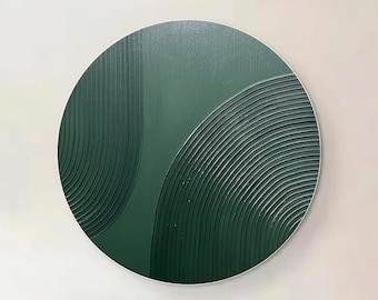 May include: A round, green wall art piece with a textured, geometric design. The art is hanging on a white wall in a living room setting.