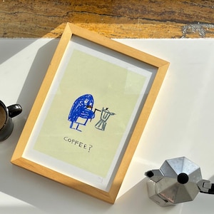 May include: A framed illustration of a blue figure holding a coffee pot with the text "COFFEE?" printed below.