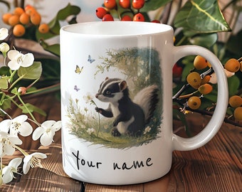 May include: White ceramic mug with a black and white illustration of a small animal with a long tail, surrounded by green foliage and butterflies. The text "Your name" is written on the bottom of the mug.