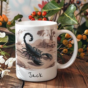 May include: White ceramic mug with a black scorpion illustration and the name "Jack" printed on the bottom.