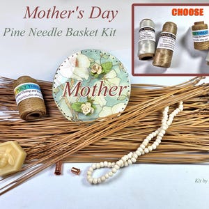 May include: A Mother's Day pine needle basket kit with various components. Includes pine needles, spools of thread, a decorative round piece with the word "Mother", a beaded necklace, and a bee-shaped soap. The kit is designed for crafting.