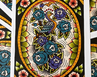 May include: A rectangular art print featuring a central oval frame containing a peacock surrounded by blue and purple roses. The background is white with black line work, while the border is yellow with green leaves and small pink flowers.