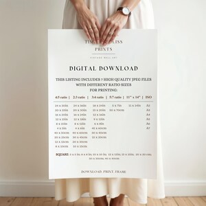 May include: A white sheet of paper with the text "TIM LISS PRINTS VINTAGE WALL ART DIGITAL DOWNLOAD" and a table listing different print sizes in inches and centimeters. The table includes the following ratios: 4:5, 2:3, 3:4, 5:7, 11" x 14", and ISO. The table also includes the corresponding paper sizes: A2, A3, A4, A5, A6, and A7.