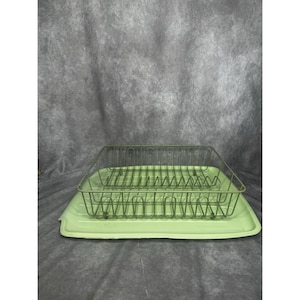 May include: A vintage-style, light green dish drainer set. The set includes a rectangular wire rack with vertical dividers and a matching tray. The drainer is designed to hold dishes and utensils for air drying.