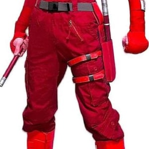 May include: A red superhero costume featuring a long-sleeved top with a logo, matching pants, boots, and wrist guards. The costume includes a utility belt and a baton. The overall design is sleek and form-fitting.
