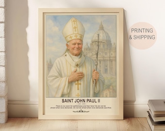 May include: A framed portrait of Saint John Paul II, featuring a detailed painting of the Pope in white and gold vestments, holding a cross. The image includes text that reads "SAINT JOHN PAUL II" and a quote. The background shows a church.