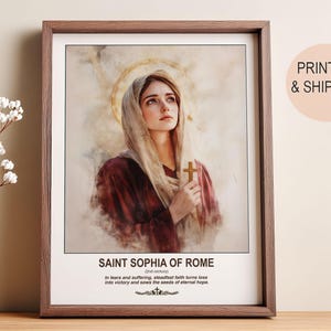 May include: Framed print of Saint Sophia of Rome. The artwork depicts a woman in a headscarf holding a cross, with a golden halo. The text at the bottom reads "Saint Sophia of Rome" and a quote. The frame is brown.