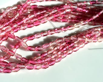 May include: Strands of faceted, oval-shaped beads in varying shades of pink and clear. The beads are strung together, creating a delicate and shimmering effect. The beads are likely made of glass or crystal, and are suitable for jewelry making.