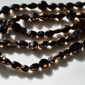 Table Cut Black with Bronze Bead Shape Medley. 25
