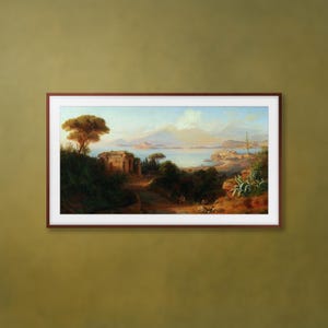 May include: A framed landscape painting depicts a coastal scene with mountains, water, and buildings. The artwork features a warm color palette with a prominent tree in the foreground and a distant mountain range.
