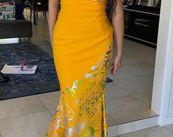 May include: A vibrant yellow off-the-shoulder dress with a fitted bodice and a flowing skirt. The skirt features a decorative pattern with silver and green accents. The dress is floor-length and suitable for special occasions.