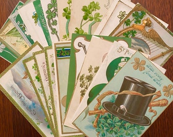 May include: A collection of vintage postcards featuring shamrocks, clovers, and St. Patrick's Day greetings. The postcards are in various shades of green, white, and gold, with some featuring illustrations of leprechauns and other Irish symbols.