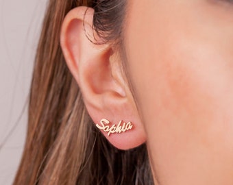 May include: Gold-toned earrings with the name "Sophia" spelled out in a cursive font.