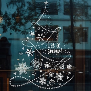 Könnte beinhalten: Ein weißes Schneeflocken-Design auf einem Glasfenster mit dem Text "Let it snow!" in einem festlichen Weihnachtsthema.