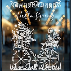 Könnte beinhalten: Weiße Linienzeichnung eines Fahrrads mit einem Korb voller Blumen auf einer Glasvitrine mit dem Text "Hello Spring" über dem Fahrrad.