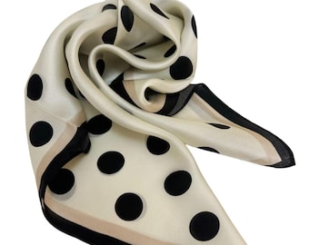 May include: A white silk scarf with black polka dots and a black and beige trim.