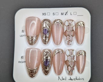 Glittery Pink Acrylic Nails with gold and white accents and hexagonal shapes