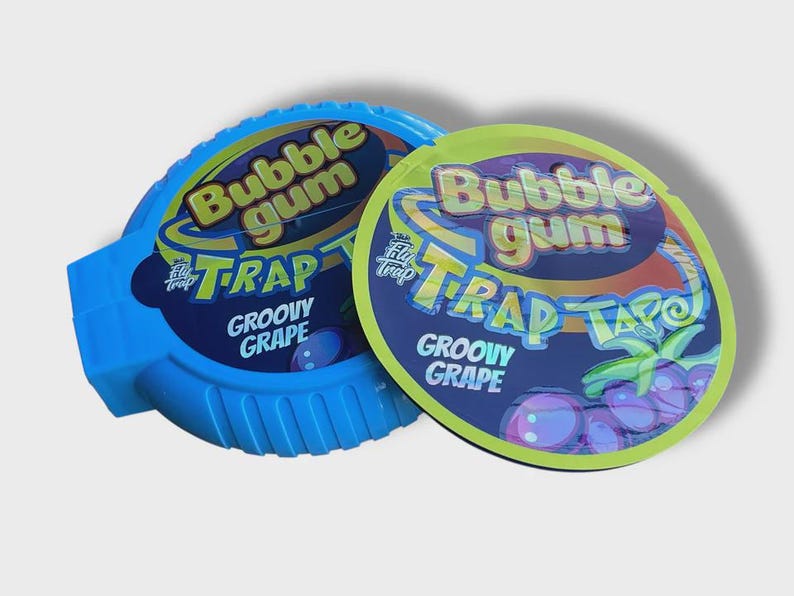 May include: Two packs of bubble gum with the text "Bubble Gum Trap Groovy Grape". One pack is blue, the other is green and yellow. The packaging features grape illustrations.