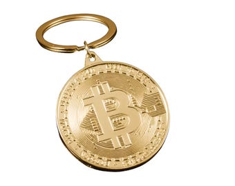 May include: A gold-colored Bitcoin keychain. The round pendant features the Bitcoin symbol and intricate detailing. The keychain includes a gold-colored ring for attaching keys.