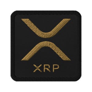 May include: A black embroidered patch with a gold XRP logo and the text "XRP" in gold.