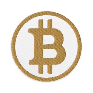 May include: A gold-colored Bitcoin symbol on a white background, surrounded by a gold-colored circle.