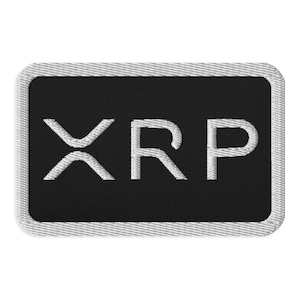May include: A black and white embroidered patch with the word "XRP" in white lettering.