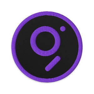 May include: Purple and black embroidered patch with a stylized letter "O" and a small dot.