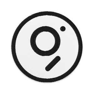 May include: A white circular patch with a black outline and a stylized black letter "g" inside.