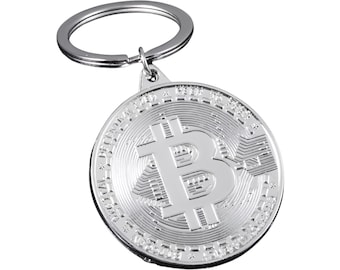 May include: Silver-toned keychain featuring a round coin with a raised Bitcoin symbol and intricate details. The keychain has a silver-toned ring.