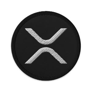 May include: Black and white embroidered patch with the letter X in a stylized font. The patch is circular and has a black background.