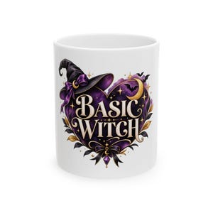 May include: A white ceramic mug featuring a heart-shaped graphic in shades of purple and black. The design includes a witch hat, a crescent moon, a bat, and the text "BASIC WITCH" in a decorative font, accented with gold stars and a purple gem.