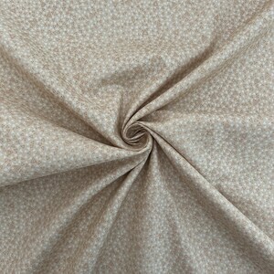 May include: Beige fabric with a repeating pattern of small brown triangles.