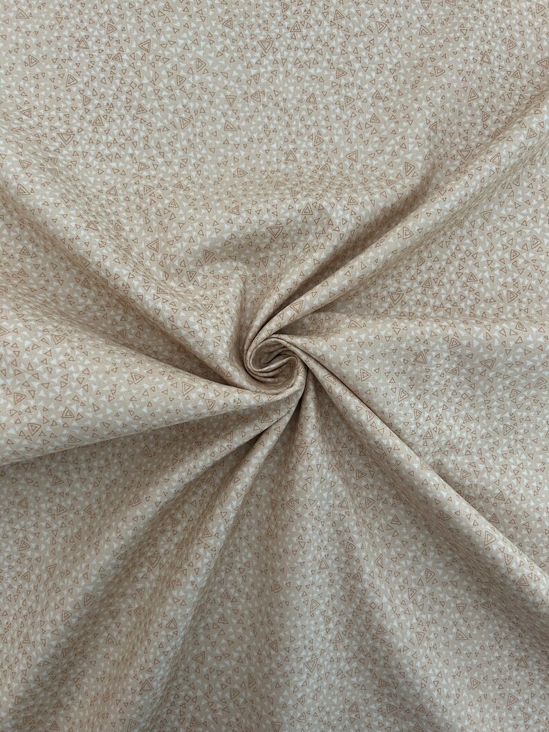 May include: Beige fabric with a repeating pattern of small brown triangles.