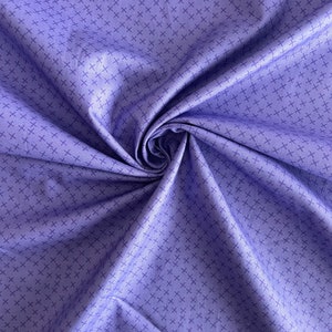 May include: A close-up of a purple fabric with a subtle crosshatch pattern. The fabric is folded and draped, showcasing its texture and drape.