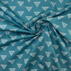 May include: Teal fabric with a repeating pattern of white, nested triangles. The fabric is gathered in a swirl, showing the texture and drape of the material. The triangles are evenly spaced across the surface.