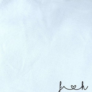 May include: A white fabric background with the word "fresh" written in black cursive with a heart in place of the "o".