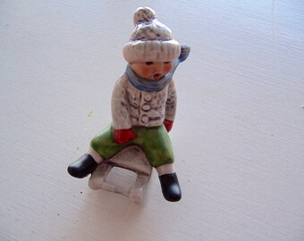 figurine / goebel boy figurine on a sled