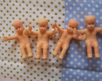 four tiny wee boy plastic dolls