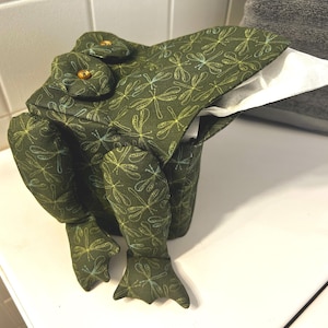 May include: A set of three ceramic mugs with a speckled, matte finish. The mugs are in shades of cream, light gray, and dark gray. Each mug has a simple, minimalist design, perfect for coffee or tea.