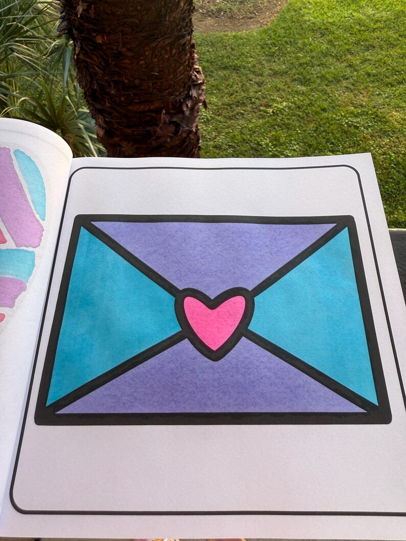 May include: A purple and blue envelope with a pink heart in the center. The envelope is outlined in black.