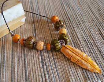 One of a kind statement beads polymer clay pendant necklace / earthy yellow feather, huge handmade beads / chunky organic distressed tribal