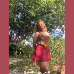May include: A colorful crochet halter top with fringe detail and a red skirt. The top features a mix of green, yellow, and pink yarns. The text "@studioniggli_knit" is at the bottom of the image.