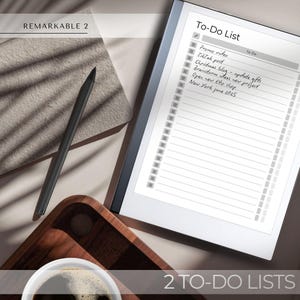 May include: A white digital notepad with a black border and the text "To-Do List" at the top. The notepad has a list of to-dos written in black ink, including "Promo video", "TikTak post", "Christmas blog - update gifts", "Brainstorm ideas new project", "Open new Etsy shop", and "New York June 2025". The notepad is lying on a light brown surface with a black stylus and a wooden tray with a cup of coffee.