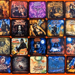 Peut inclure: Une collection de vingt écussons carrés en tissu présentant diverses illustrations d'albums et images du groupe King Diamond, chacun avec une bordure noire cousue, disposés en grille sur un fond orange vif.
