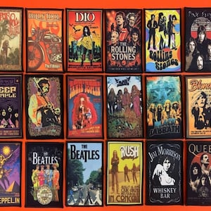 May include: A collection of eighteen rectangular fabric patches featuring iconic rock band imagery and text, including Jethro Tull, Billy Idol, Dio, The Rolling Stones, Deep Purple, Jimi Hendrix, Janis Joplin, Black Sabbath, Blondie, Led Zeppelin, The Beatles, Rush, Jim Morrison, and Queen.
