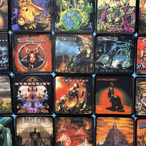 May include: A collection of square patches featuring various designs, including band logos and album art. The patches display a range of colors, with images of skulls, figures, and text. The patches are likely for clothing or accessories.