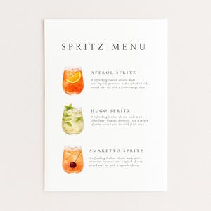 May include: A white menu card featuring the title "SPRITZ MENU" in black. It displays watercolour illustrations of three spritz cocktails: Aperol, Hugo, and Amaretto. Each drink is described with a short text in a simple, elegant font.