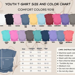 May include: A youth t-shirt size and colour chart displaying Comfort Colors 9018 t-shirts in a range of colours, such as white, black, and blue jean. The chart includes size, length, and width measurements in inches, plus care instructions.