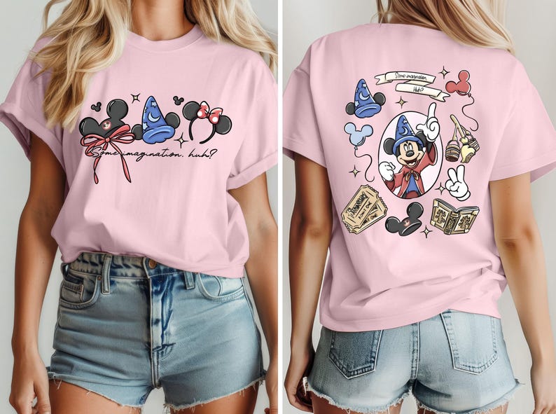 May include: Pink t-shirt featuring Disney-themed graphics. The front displays Mickey Mouse ears, a sorcerer's hat, and Minnie Mouse ears with text that reads "Some imagination, huh?" The back shows Mickey Mouse as a sorcerer.